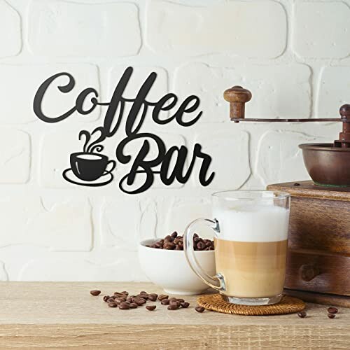 Coffee bar sign with coffee grinder and latte on counter.