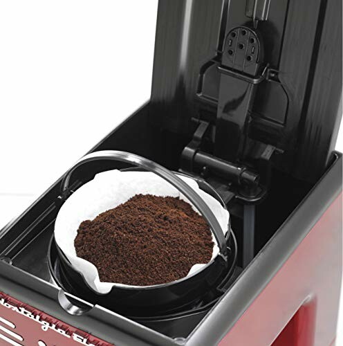 Coffee maker with filter and coffee grounds inside.