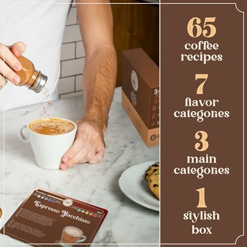 Person pouring cinnamon on coffee with recipe box and booklet.