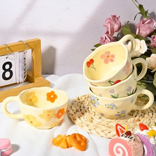Stack of floral teacups with calendar and decorations