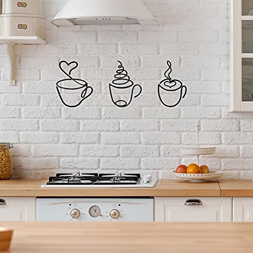 Kitchen with coffee cup wall art above stove.