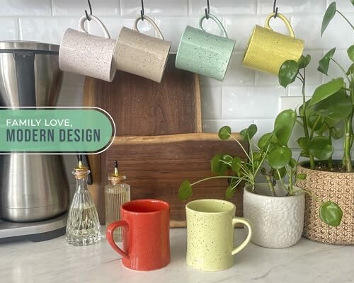 Modern kitchen with mugs, plants, and appliances.