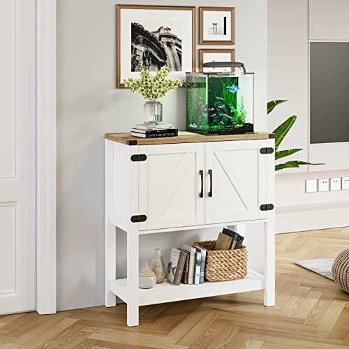 A modern white cabinet with fish tank and decor items