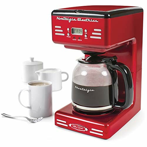 Red coffee machine with full glass carafe and two white mugs.