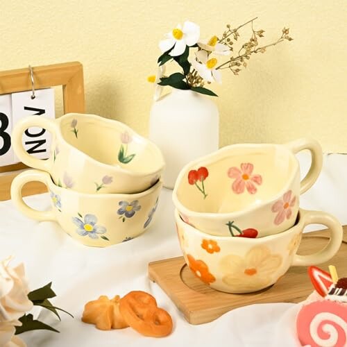 Stacked floral ceramic cups with a vase and flowers