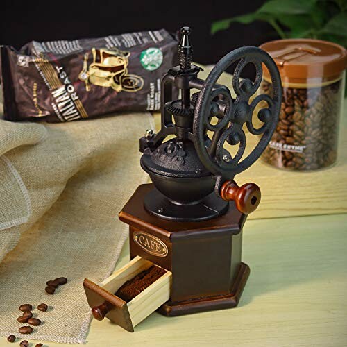 Vintage coffee grinder with coffee beans and bag.