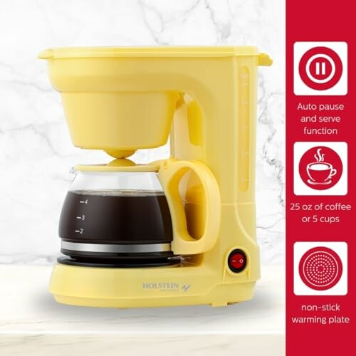 Yellow coffee maker with pot and control panel.